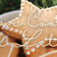 Picture of sugar cookies with white icing on background of a Christmas tree. Text says sugar cookie tea latte